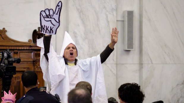 A Code Pink activist dressed like a member of the KKK disrupts the start of the Senate Judiciary Committee confirmation hearing for Senator Jeff Sessions.