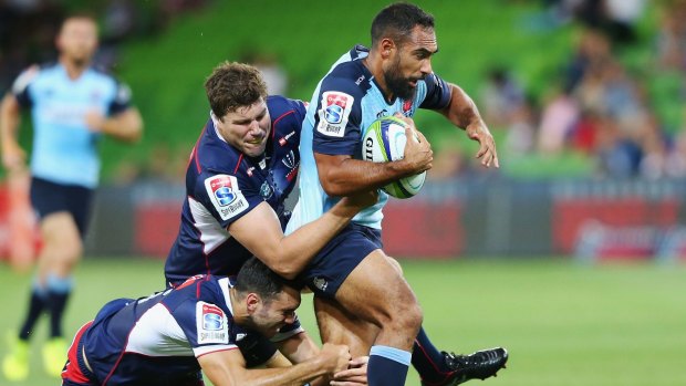 Reece Robinson of the Waratahs is tackled during the round-five Super Rugby match between the Rebels and the Waratahs at AAMI Park.