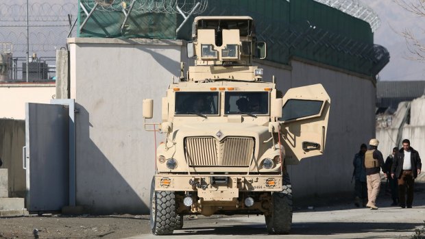 A US military vehicle blocks a road to a logistics company near the site of a deadly suicide attack in Kabul earlier this month. The Taliban claimed responsibility for the attack.