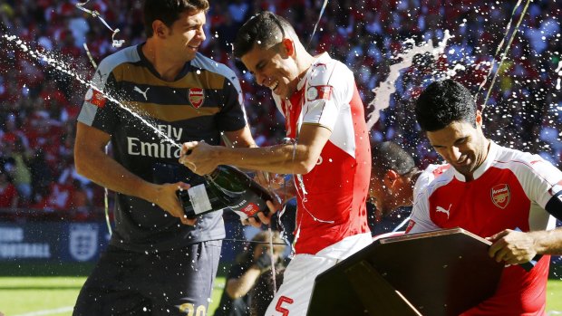 Mikel Arteta and Gabriel Paulista celebrate after winning the FA Community Shield.