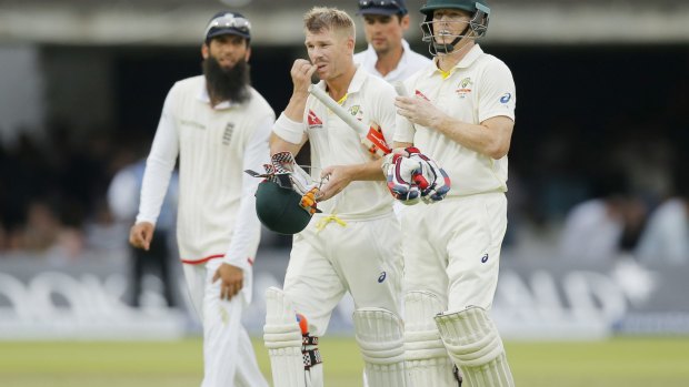 Australia's David Warner (centre) walks off at the end of play after a successful day.