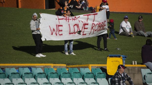 Confiscated: Tigers fans show their support for Farah.