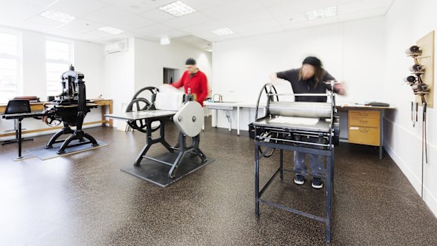 Working on presses at Megalo Print Studio and Gallery.