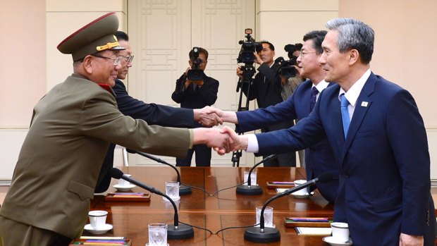 South Korean security officials, right, shake hands with officials from North Korea at the border village of Panmunjom.