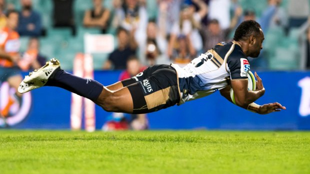 No sidestep: Kuridrani crosses for the Brumbies after barging past Nick Phipps.