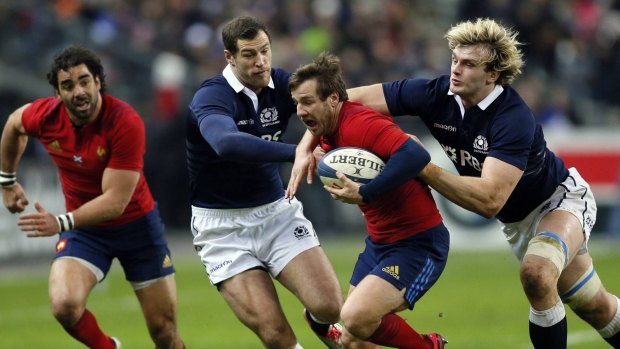 Match winner: Camille Lopez attempts to break the Scottish line. It was his boot that saved France.