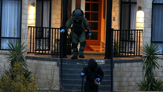 Bomb squad officers at the Melbourne property on Friday night.
