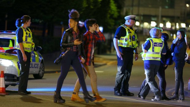 Concertgoers leave the Manchester Arena after the attack. 