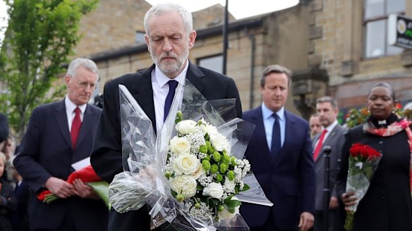Labour leader Jeremy Corbyn, front, is flanked by the MP for Leeds Central Hilary Benn, Prime Minister David Cameron and the Chaplain to the Speaker of the House of Commons Reverend Rose Josephine Hudson-Wilkin as they lay flowers in memory of Jo Cox.
