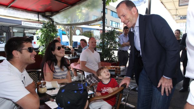 Tony Abbott has morning tea with local families in a Sydney cafe.