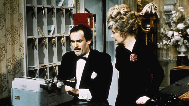 Fawlty Towers: Basil and Sybil  at the front desk. 