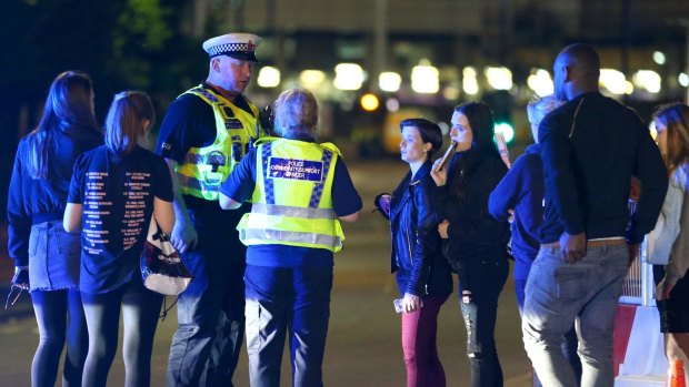 Police and fans close to the Manchester Arena after the attack.