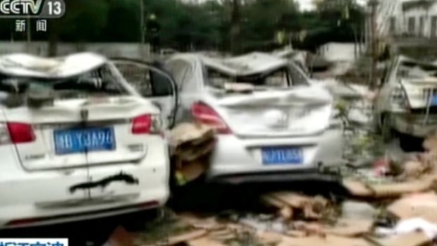This image from video run by China's CCTV shows debris and damaged vehicles following an explosion in Ningbo in China.