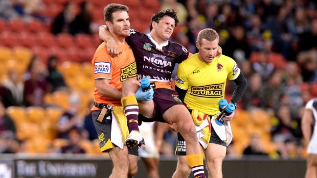 Clipped wings: Broncos paceman and Origin hopeful James Roberts is carried from the field after his leg collided with a teammate.