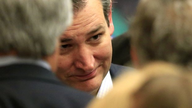 Republican presidential candidate Senator Ted Cruz listens to supporters at a caucus site.