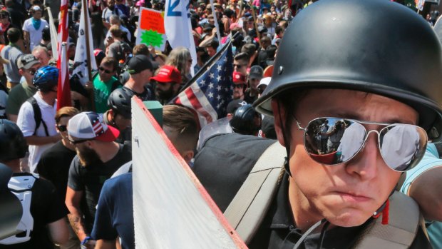 A white nationalist demonstrator with a helmet and shield marches in Charlottesville. 