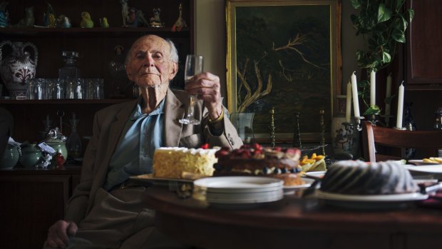 Centenarian Victor Lederer enjoys a glass of wine at his Canberra home.
