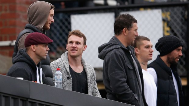 Jake King (in red hat) with other Richmond players including Tyrone Vickery (in brown hoodie) at a VFL game in 2014.