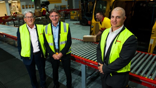 DHL Express Oceania CEO Gary Edstein, global chief of express services Ken Allen and local branch manager Careg Pretorius with courier Tony Kingston at the new freight forwarding facilities in Fyshwick.