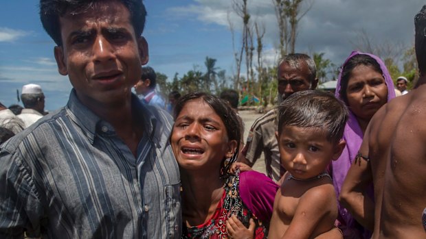 Rohingya Muslims, who crossed over from Myanmar into Bangladesh, mourn for a family member who drowned when the boat they were traveling in capsized minutes before reaching the shore, at Shah Porir Dwip, Bangladesh.