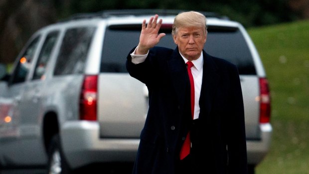 US President Donald Trump waves as he leaves the White House on Friday.