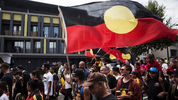 People take part in an Invasion Day march in Sydney on January 26, 2016. 