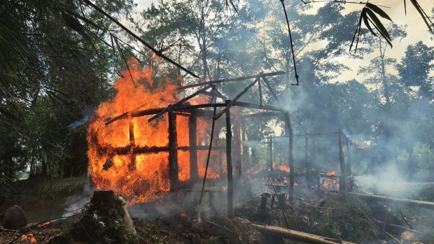 Houses on fire in Gawdu Zara village, northern Rakhine state. Soldiers set fire to homes and shot civilians as they tried to escape, according to accounts published by human rights groups.