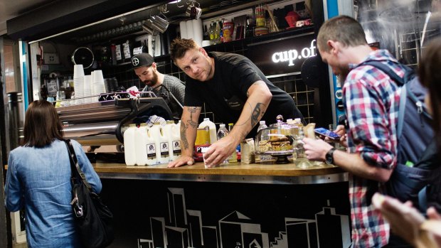 Baristas John 'The Textbook' Freeman, left, and Courtney 'The Architect' Patterson serve early morning coffee at Cup Of Truth coffee shop below Flinders Street in Melbourne.

