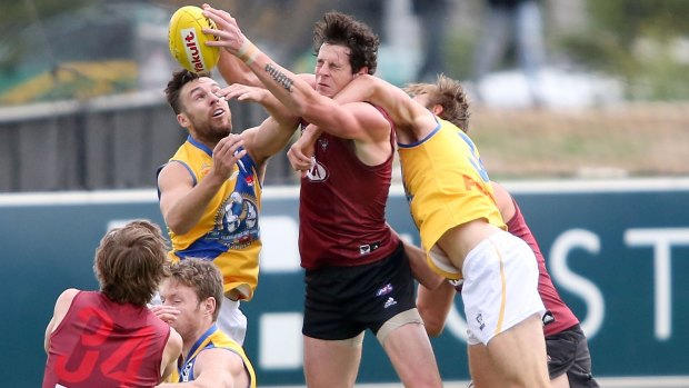 Essendon's Jake Carlisle tries to outmark two Williamstown opponents. 