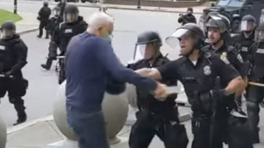 In this image from video provided by WBFO, a Buffalo police officer appears to shove a man who walked up to police Thursday, June 4, 2020, in Buffalo, N.Y. Video from WBFO shows the man appearing to hit his head on the pavement, with blood leaking out as officers walk past to clear Niagara Square. Buffalo police initially said in a statement that a person “was injured when he tripped & fell,” WIVB-TV reported, but Capt. Jeff Rinaldo later told the TV station that an internal affairs investigation was opened. Police Commissioner Byron Lockwood suspended two officers late Thursday, the mayor’s statement said. (Mike Desmond/WBFO via AP)