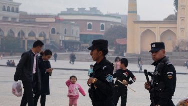 Security personnel on patrol outside a mosque frequented by Uighurs in Xinjiang.