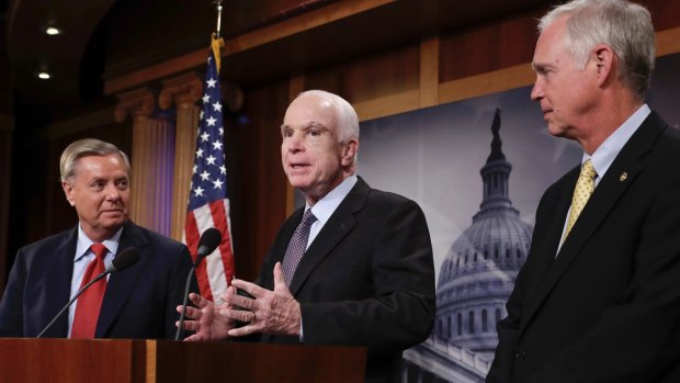 John McCain speaks as Lindsay Graham, left, and Ron Johnston, right, listen during a press conference in Washington.