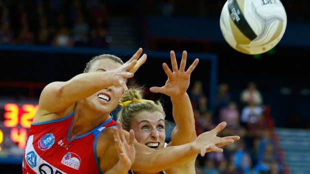 Gabi Simpson of the Queensland Firebirds competes for the ball with Kimberlee Green of the NSW Swifts during the 2016 ANZ Championship Grand Final match at Brisbane Entertainment Centre.