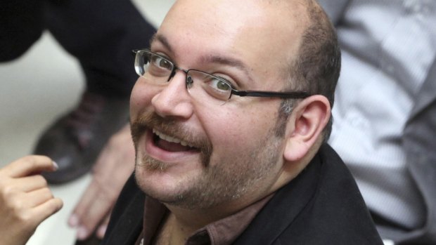 Languishing: Jason Rezaian, an Iranian-American correspondent for the Washington Post, attends a presidential campaign of President Hassan Rouhani in Tehran, Iran, in 2013. 