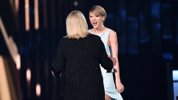 Andrea Swift presents the milestone award to her daughter Taylor Swift at the 50th annual Academy of Country Music Awards at AT&T Stadium on Sunday, April 19, 2015, in Arlington, Texas.