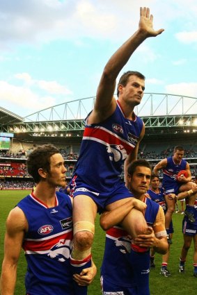 Luke Darcy is chaired off after his final game for the Bulldogs.