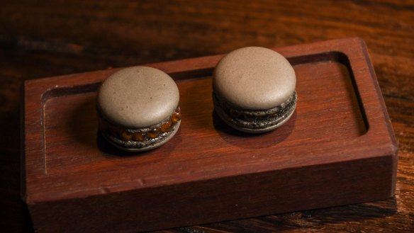 Signature black garlic macarons filled with salmon roe are available in the restaurant and its adjacent bar.