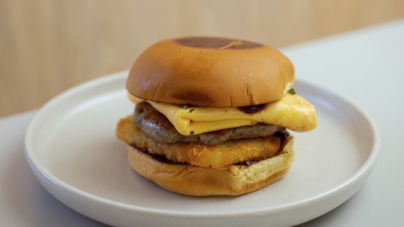 Breakfast burger with pork and fennel patty, melted American cheese, fried, folded egg and hash brown.