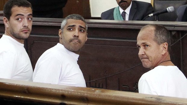 Al-Jazeera English producer Baher Mohamed, left, Canadian-Egyptian Acting Cairo Bureau Chief Mohamed Fahmy, centre, and correspondent Peter Greste, right, face court in Cairo in 2014.  The Qatari channel's reporting has been a major source of tension between Doha and its Arab neighbours. 