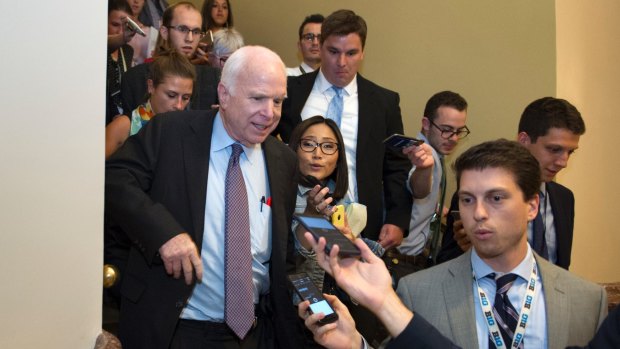 John McCain is pursued by reporters after casting a 'no' vote on a a measure to repeal parts of Obamacare.