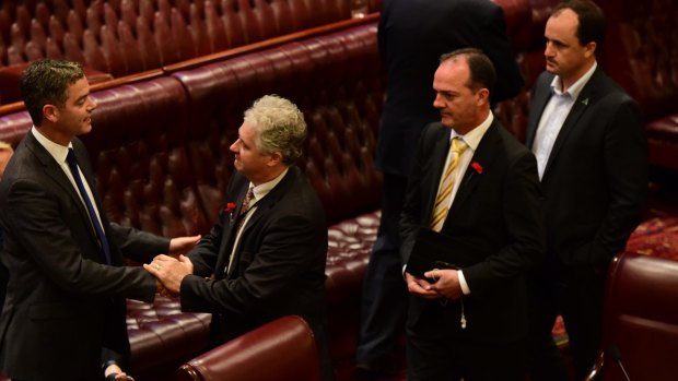 Other members congratulate Mr Graham after his speech, which called for policy changes in NSW.