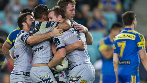 Upset: Cowboys celebrate a try to Michael Morgan.