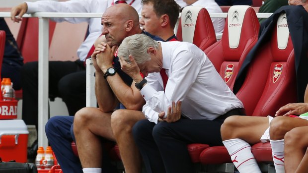 Football - Arsenal v West Ham Can't watch: Arsenal manager Arsene Wenger appears dejected as assistant manager Steve Bould looks on.