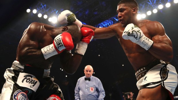 Britain's Anthony Joshua (right) beats Cameroon's Carlos Takam to win the IBF, IBO  and WBA titles in October.