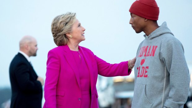 Democratic presidential candidate Hillary Clinton, accompanied by singer Pharrell Williams arrives at Raleigh-Durham International Airport in Morrisville, North Carolina.
