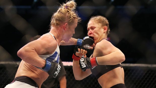Holly Holm lands one on the face of Ronda Rousey in their UFC title fight last Sunday in Melbourne. 