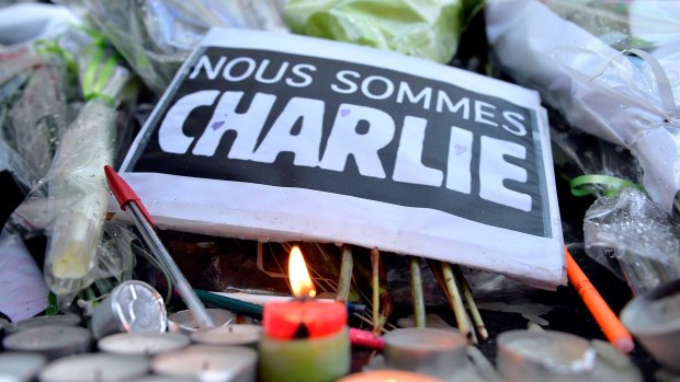 Tributes of drawings, flowers, pens and candles are left in front of the Charlie Hebdo offices following the attack.