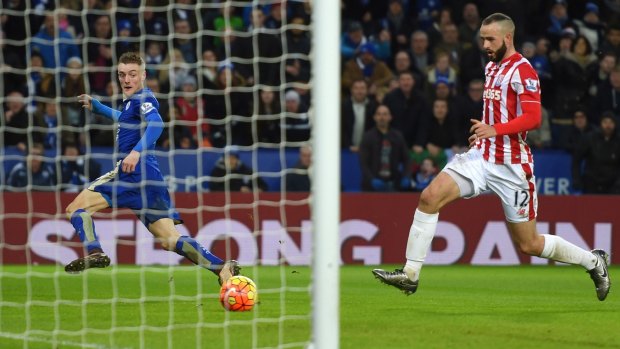 Top dogs: Jamie Vardy slides home the Foxes' second goal. 