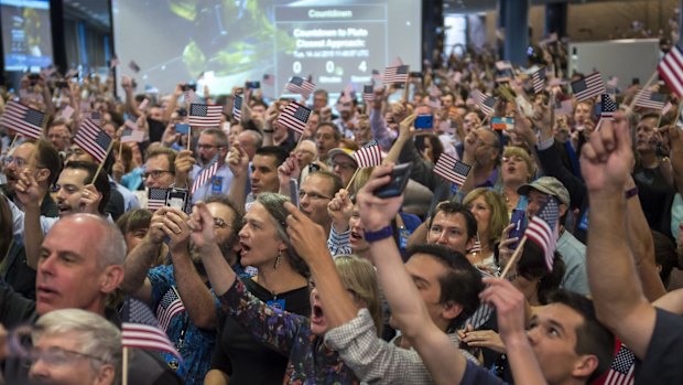 Guests and New Horizons team members count down to the spacecraft's closest approach to Pluto.