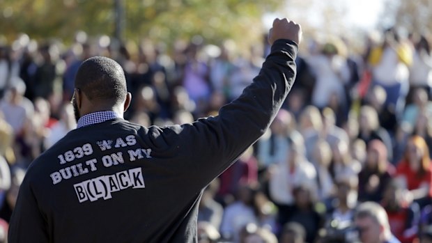 A member of the black student protest group Concerned Student 1950 gestures while addressing a crowd at the University of Missouri.